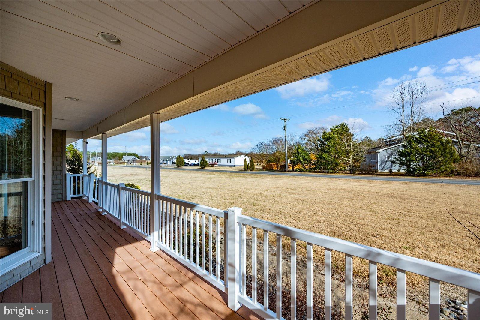 32271 West Road Frankford, DE 19945 - Photo 7 of 56 Inviting porch with serene landscape views.
