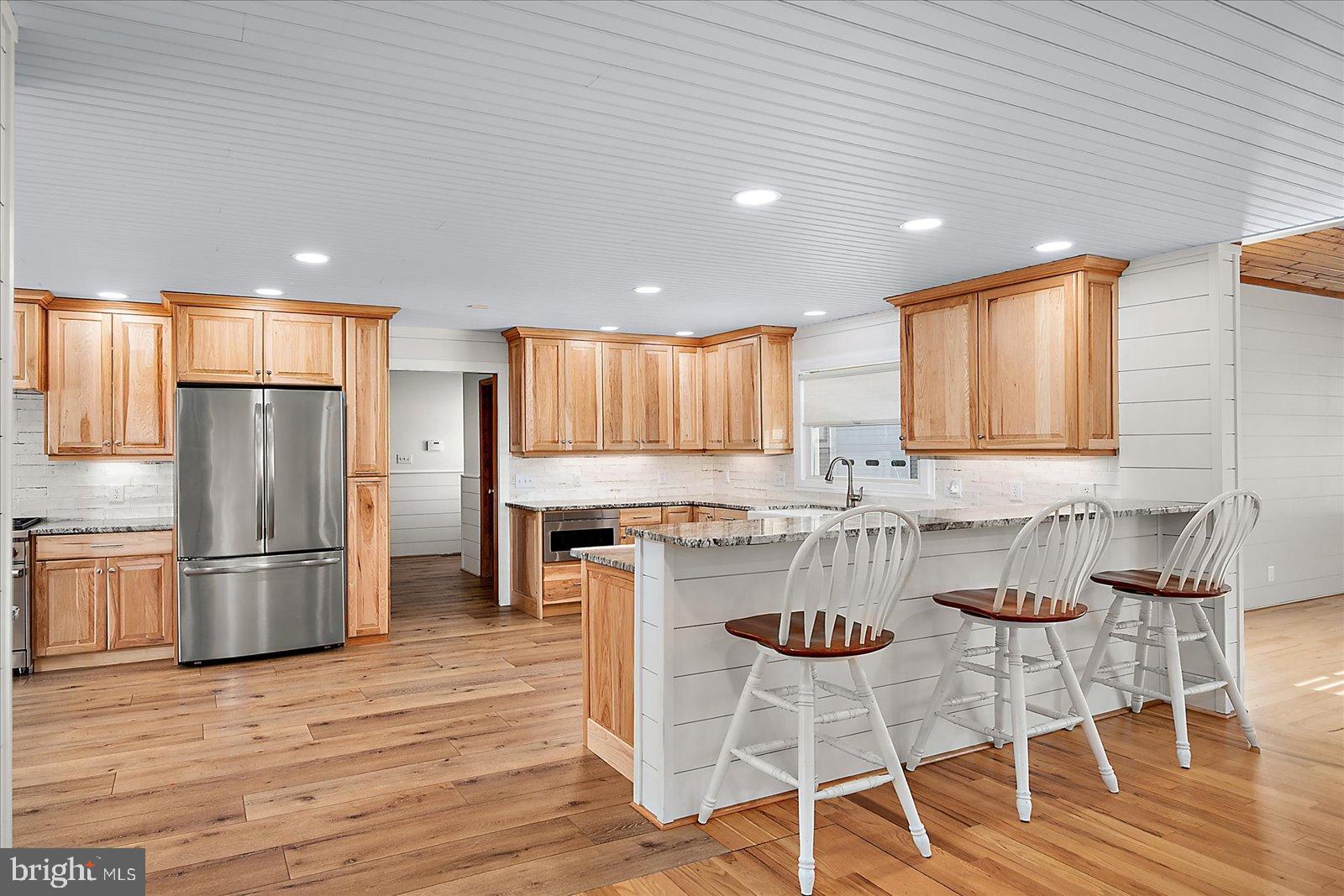32271 West Road Frankford, DE 19945 - Photo 9 of 56 Bright, modern kitchen with warm wood accents.