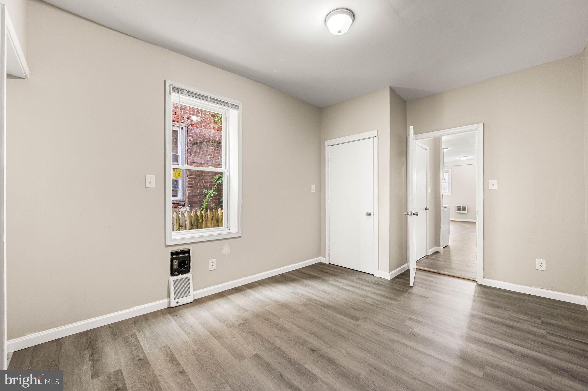 2030 South Cecil Street, Unit 1 Philadelphia, PA 19143 - Photo 10 of 11 an empty room with wooden floor and windows
