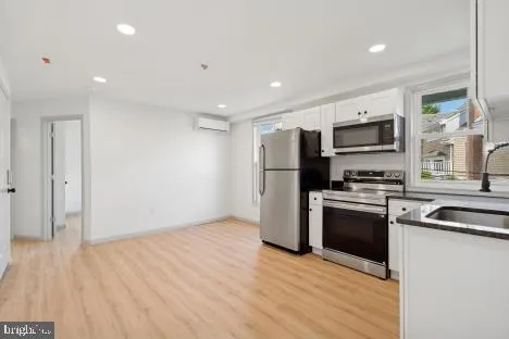 a kitchen with a refrigerator and a stove top oven