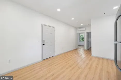 a view of hallway with wooden floor