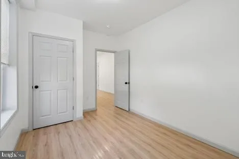 a view of an empty room with wooden floor