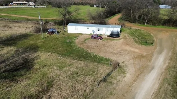 an aerial view of a house with a yard