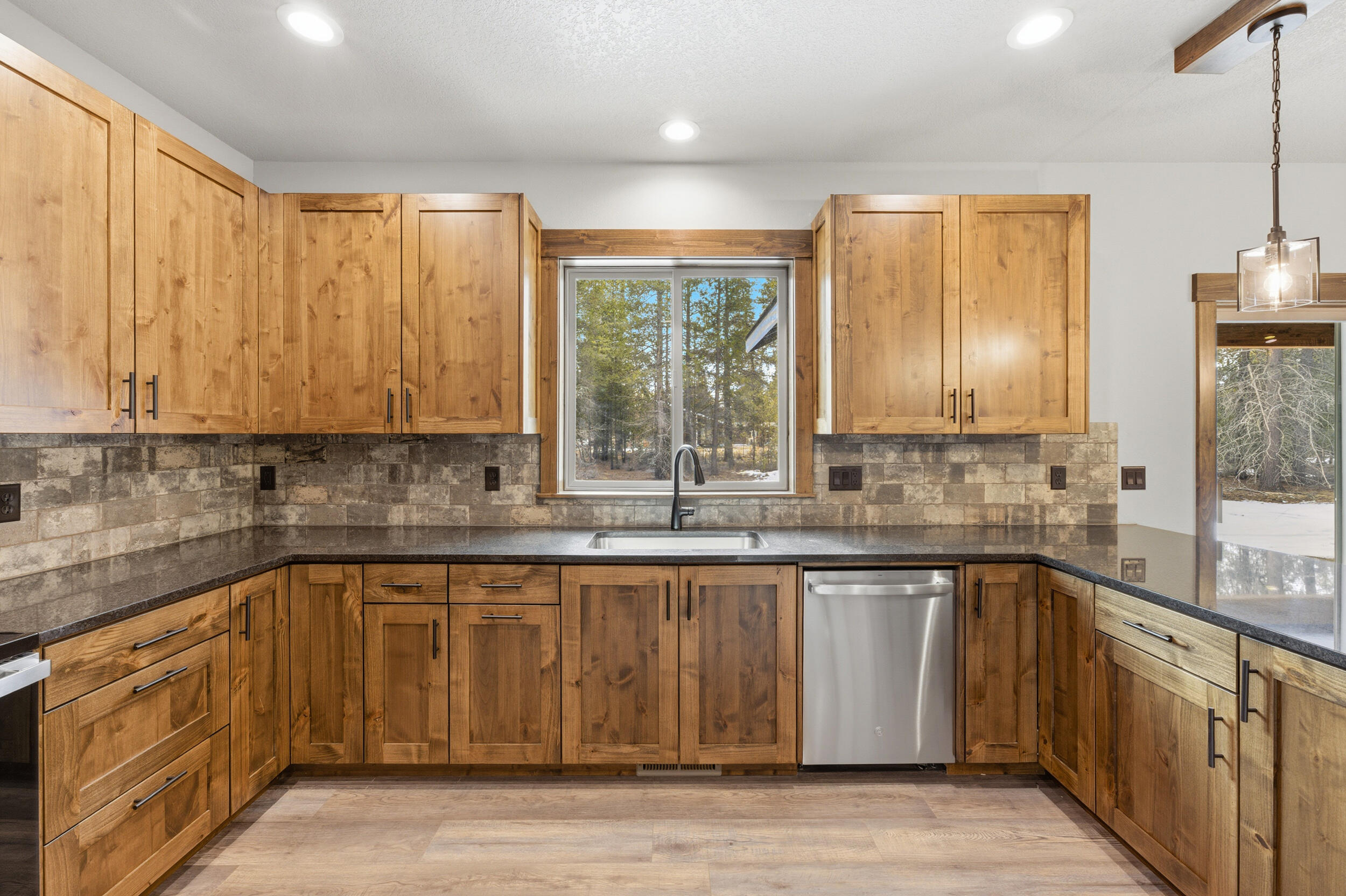 16083 Dyke Road, Unit 9 La Pine, OR 97739 - Photo 15 of 53 a kitchen with stainless steel appliances granite countertop a sink a stove and cabinets