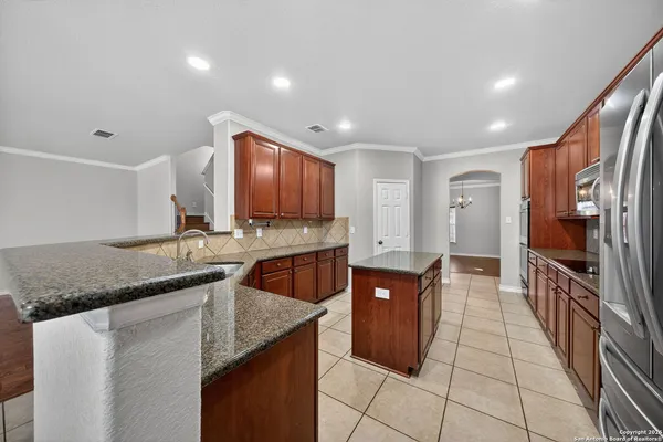 a kitchen with stainless steel appliances granite countertop a sink and a stove