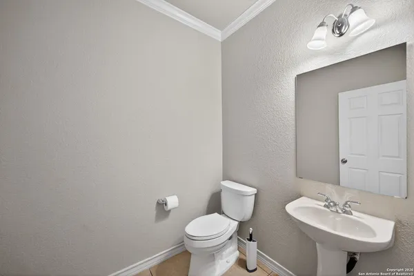 a bathroom with a sink toilet and a mirror