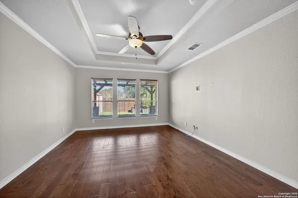 wooden floor in an empty room with a window