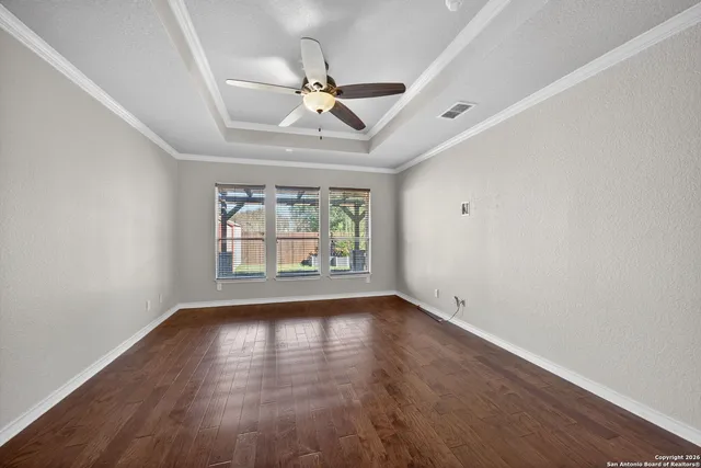 wooden floor in an empty room with a window