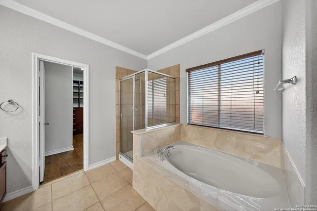 a bathroom with a bathtub and shower