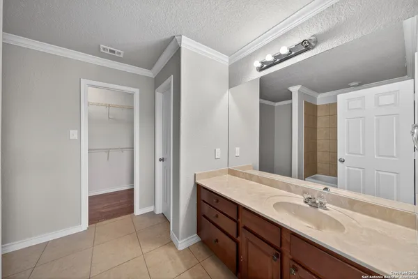 a bathroom with a double vanity sink and a mirror