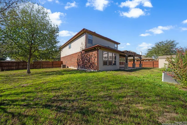 a view of a house with a yard and sitting area