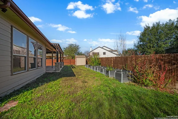 a view of backyard of house with green space