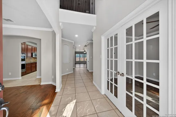 a view of a hallway with wooden floor and windows