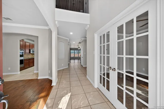 a view of a hallway with wooden floor and windows