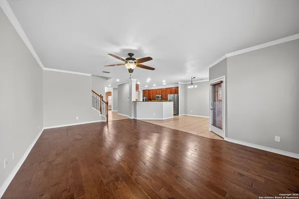 a view of an empty room with wooden floor