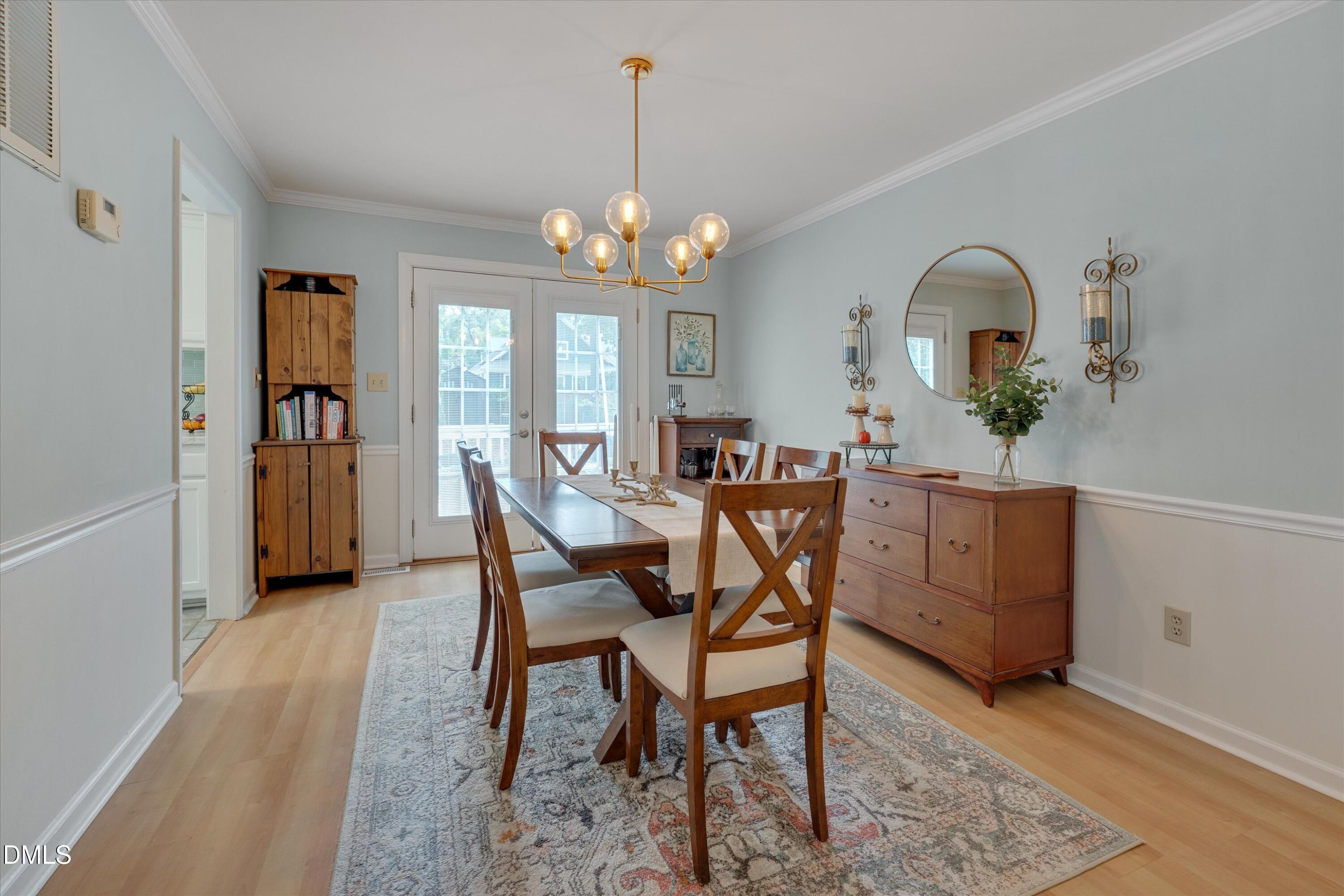 3301 Lassiter Street Durham, NC 27707 - Photo 10 of 32 a view of a dining room with furniture and chandelier