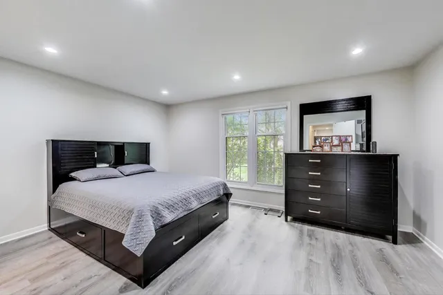 a bedroom with a bed and a dresser