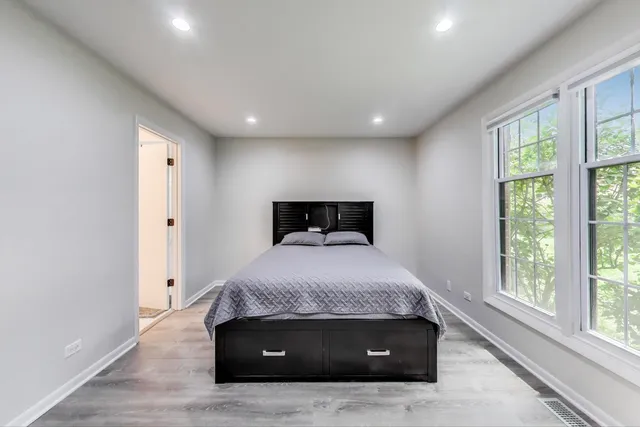 a bedroom with a bed and a window