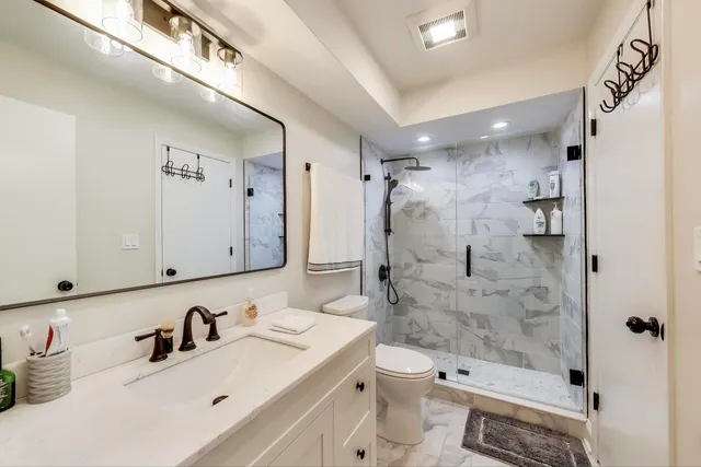 a bathroom with a sink toilet tub and shower