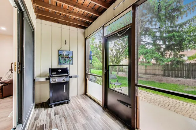 a view of a hallway with wooden floor and a swing