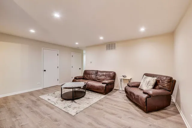 a living room with furniture a couch and a rug