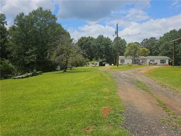 a view of a field with an trees in the background