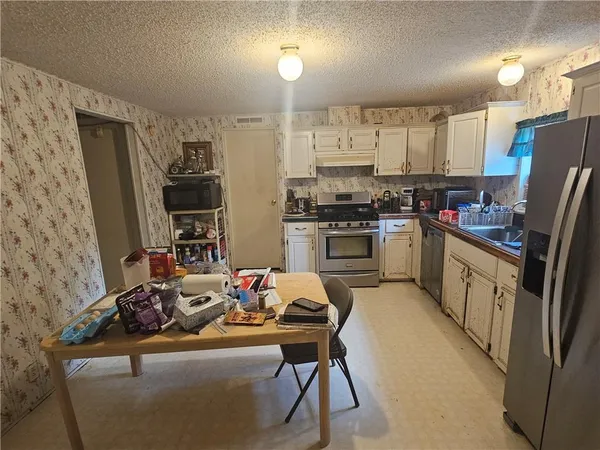 a room with water heater and shelf