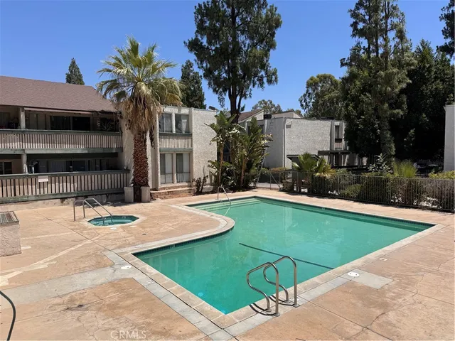a view of a house with swimming pool and sitting area