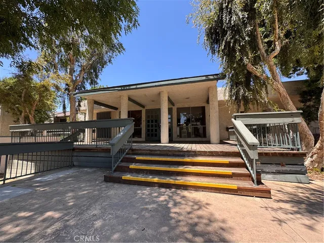 a view of house with wooden floor and a large tree