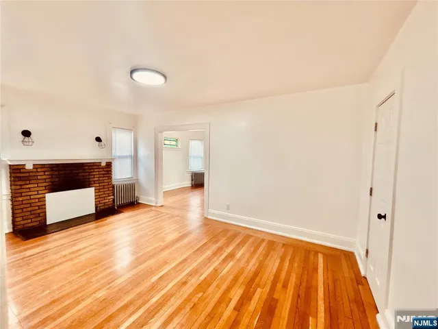 a view of a room with wooden floor and a sink