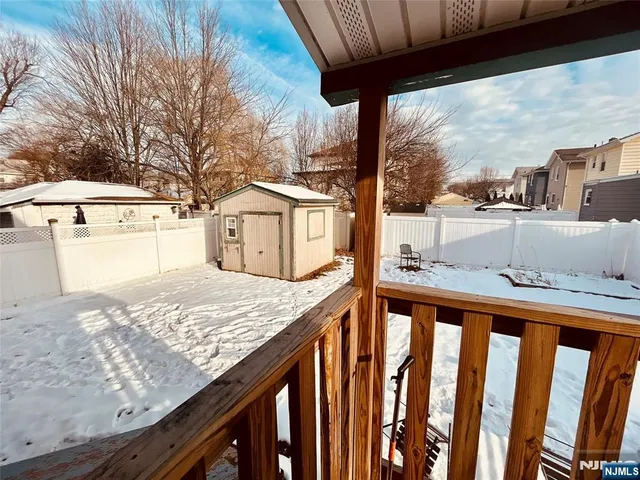 a view of a backyard with wooden fence