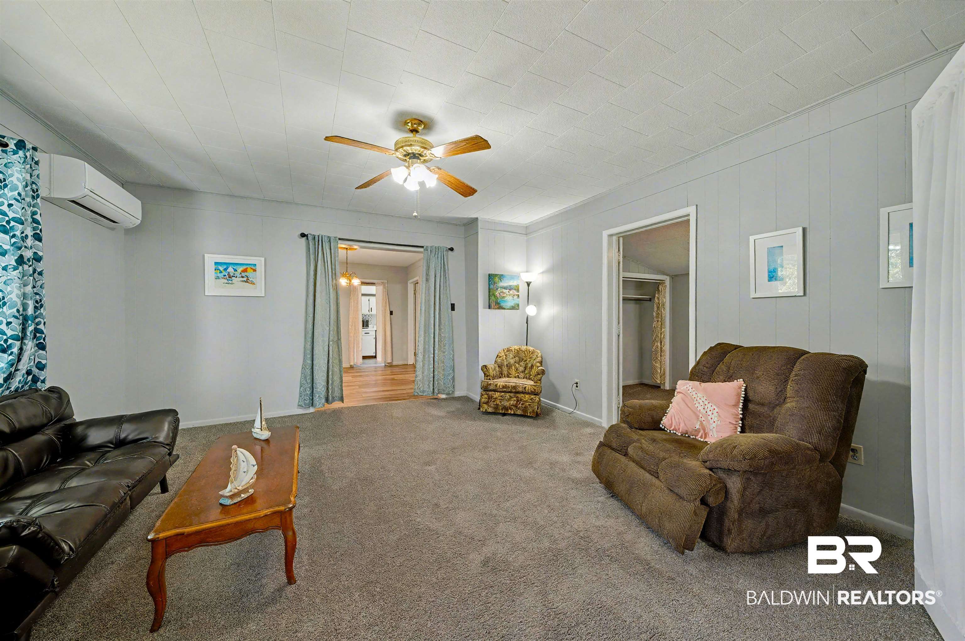 209 West Magnolia Avenue Foley, AL 36535 - Photo 8 of 23 Carpeted living area featuring ceiling fan and a wall unit AC