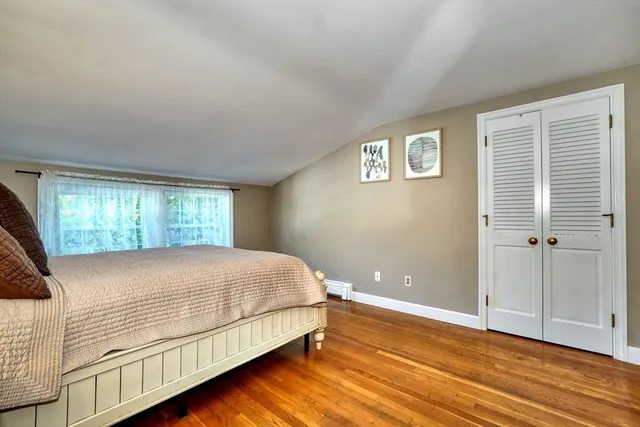 a bedroom with a bed and window