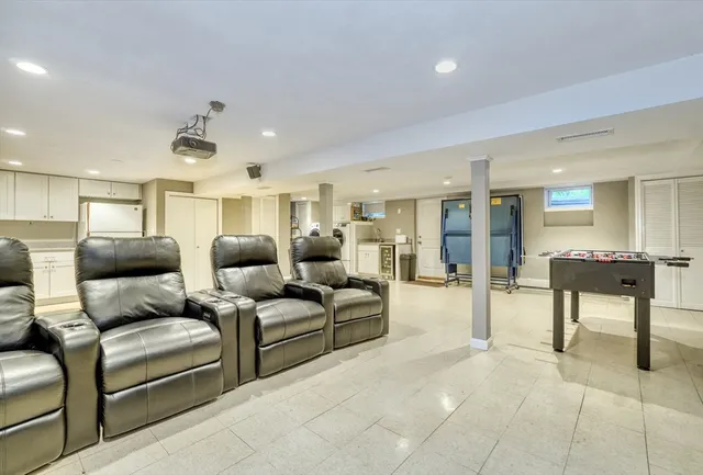 a living room with furniture and a dining table with kitchen view