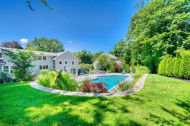 a view of backyard with garden and outdoor seating