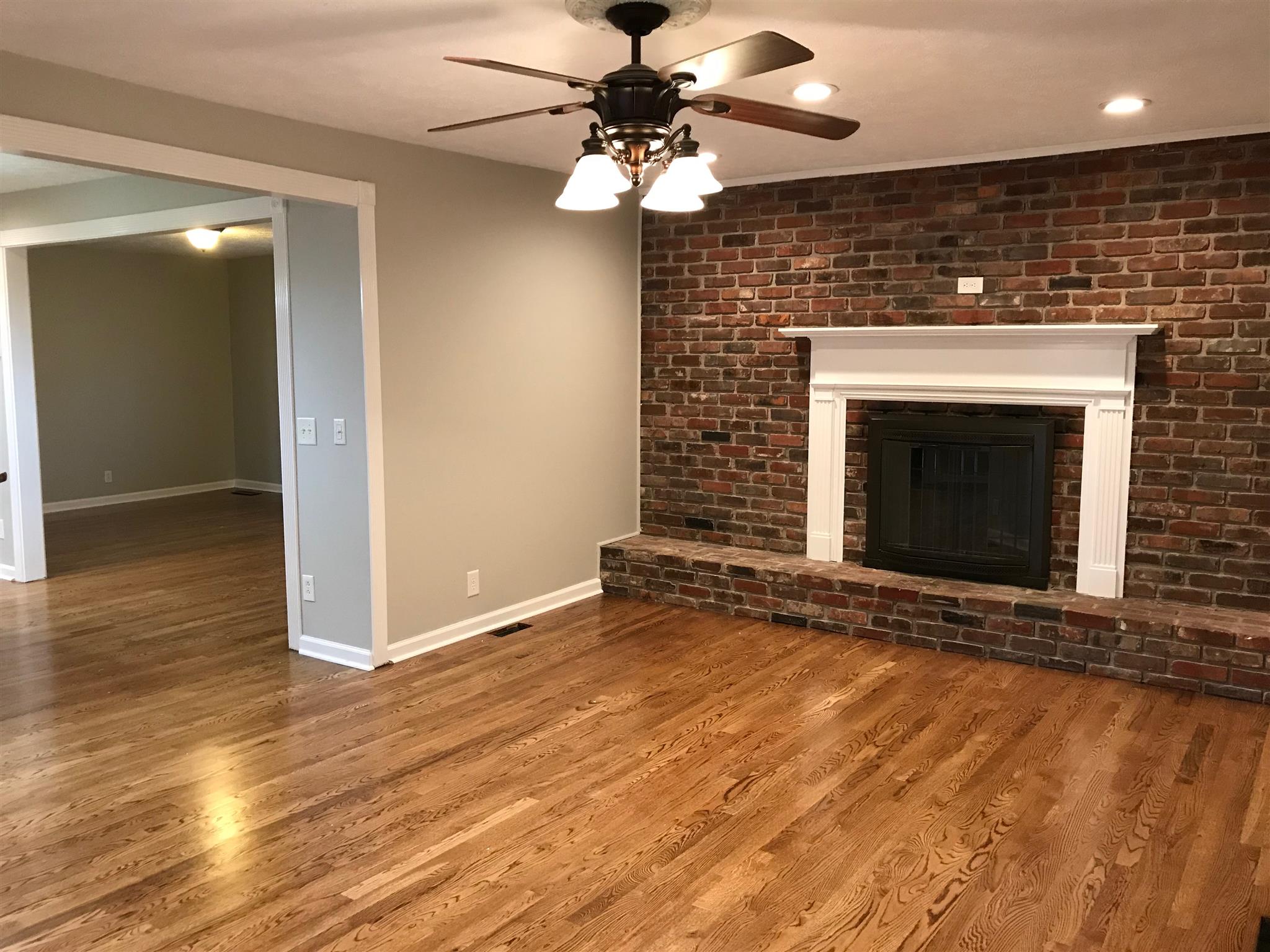 7202 Meadowwood Road Fairview, TN 37062 - Photo 17 of 30 Floors were refinished for a New Fresh Look! That is a Wood Burning Fireplace with nice glass cover that makes the fire look amazing! Lot's of cut and seasoned firewood remains and is stacked outside