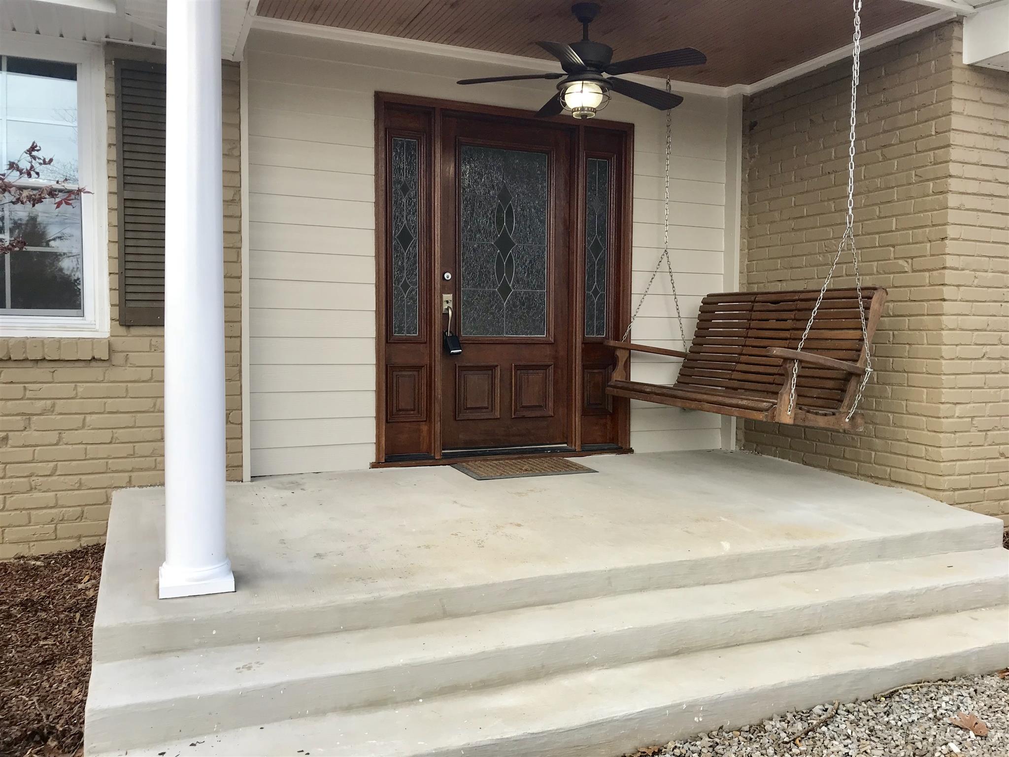 7202 Meadowwood Road Fairview, TN 37062 - Photo 3 of 30 Front Patio with a Ceiling Fan and Swing. There is a Beautiful Japanese Maple that is on the left but has began to lose its leaves