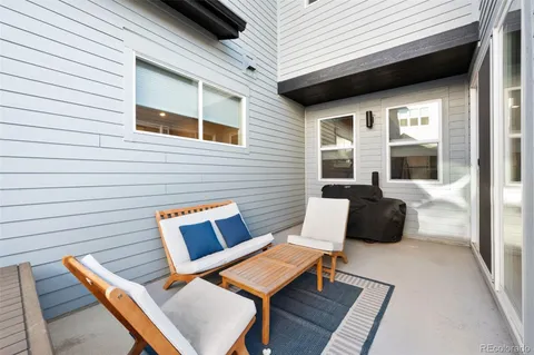 a balcony with furniture and a rug