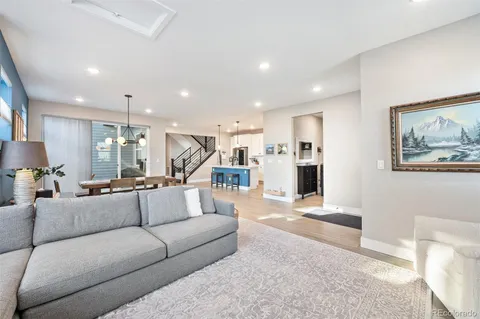 a living room with furniture and kitchen view