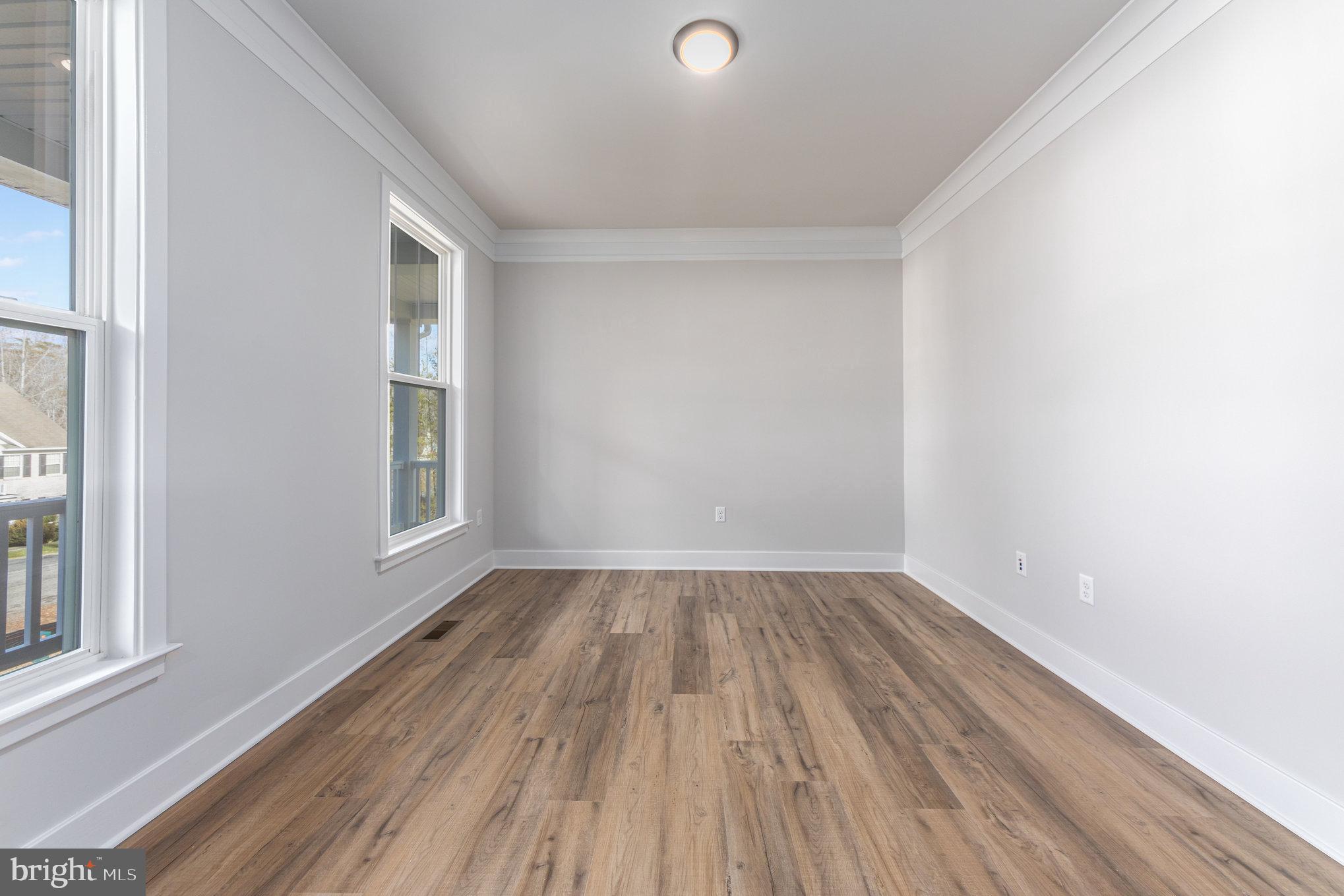 159 Norman Road Stafford, VA 22554 - Photo 7 of 55 a view of an empty room with wooden floor and a window