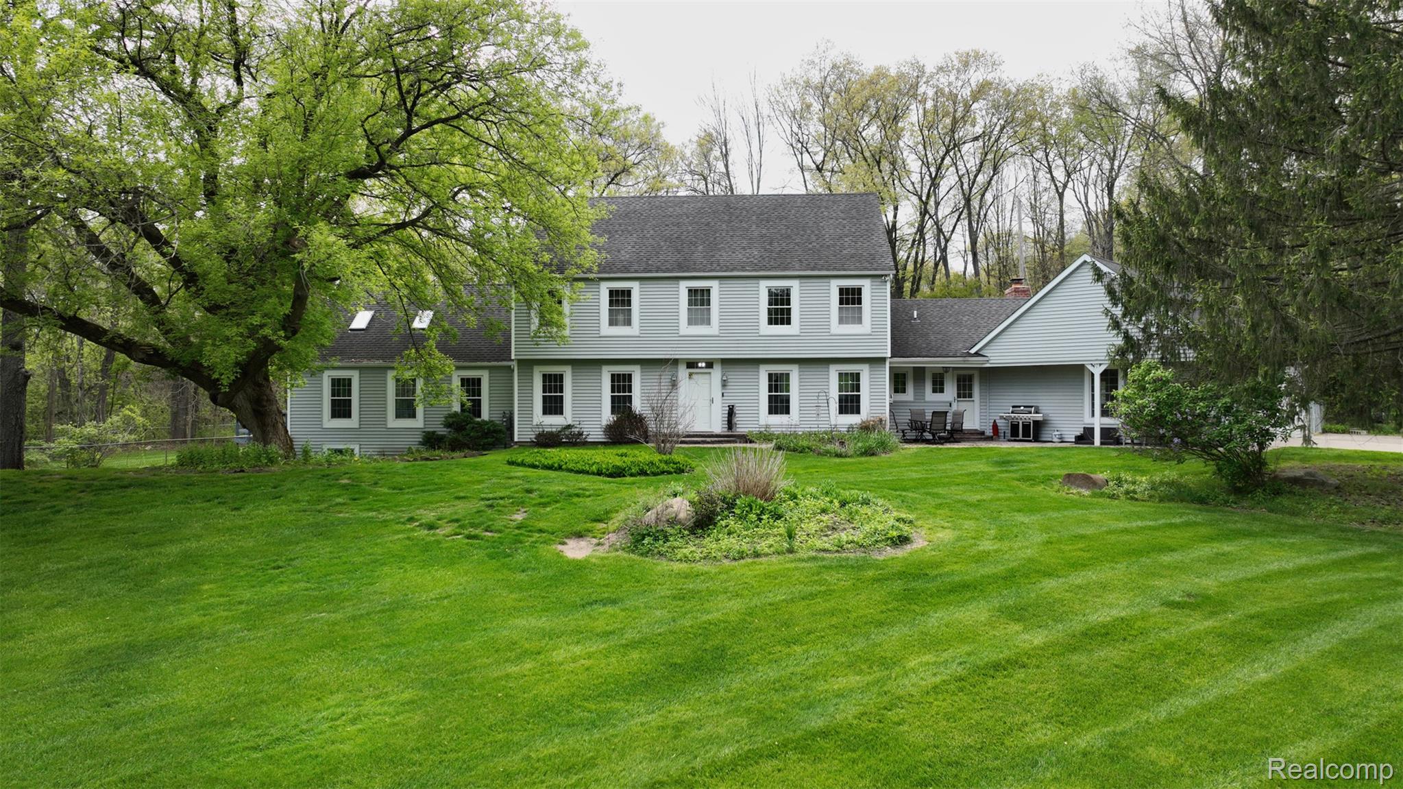 10300 Clark Road Davisburg, MI 48350 - Photo 1 of 39 Rear view of property featuring a yard