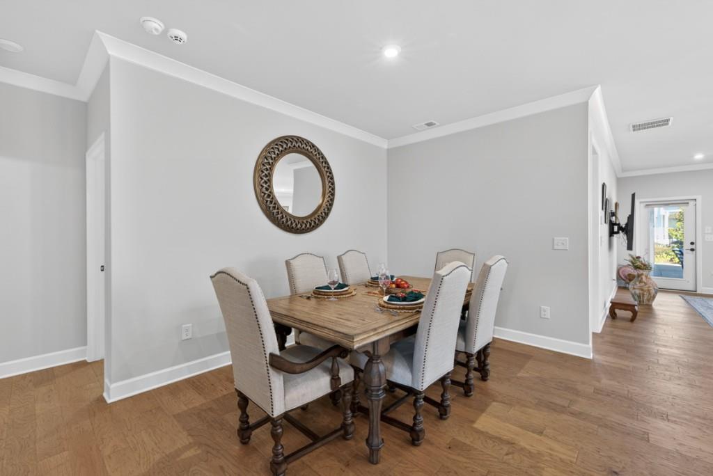 5162 Morrell Road Hoschton, GA 30548 - Photo 16 of 53 a view of a dining room with furniture and wooden floor