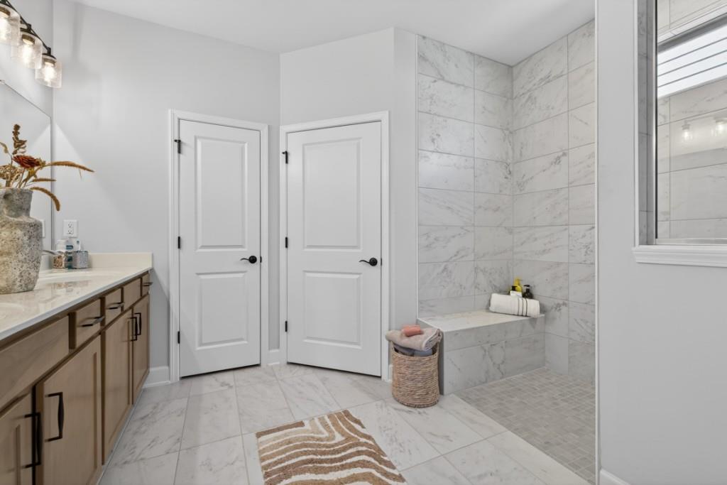5162 Morrell Road Hoschton, GA 30548 - Photo 23 of 53 a spacious bathroom with a granite countertop sink and toilet