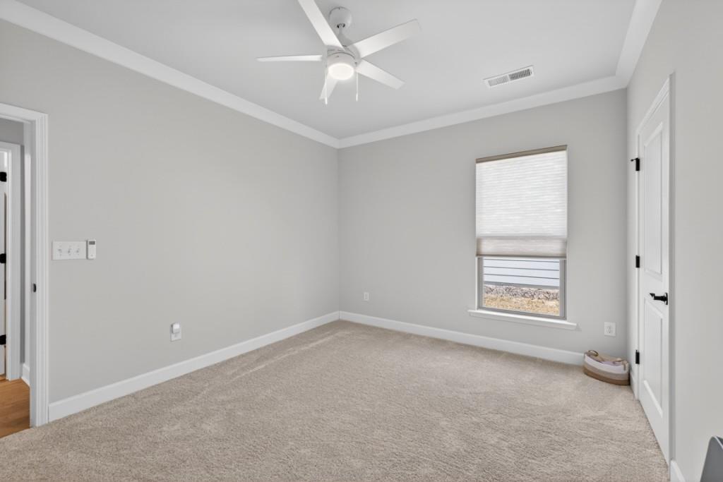5162 Morrell Road Hoschton, GA 30548 - Photo 26 of 53 an empty room with a window and a fan