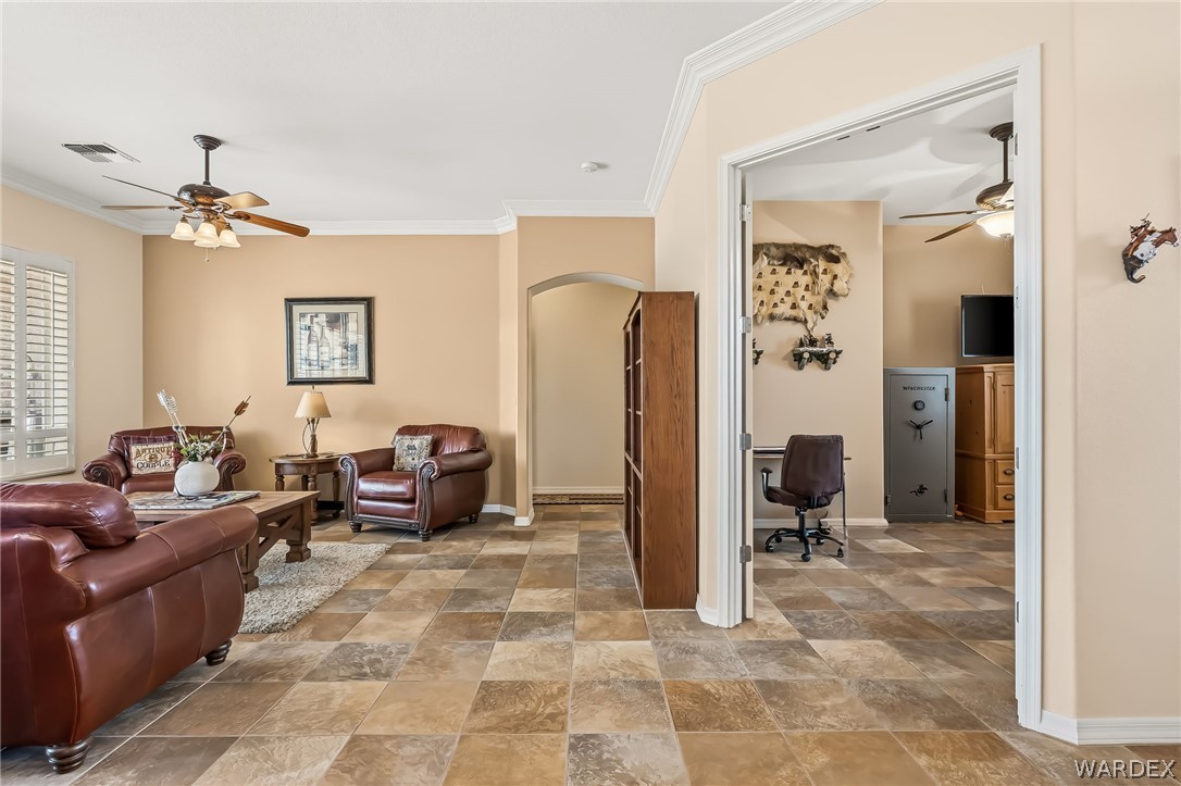 2708 Discovery Road Bullhead City, AZ 86442 - Photo 17 of 90 This property features a living area with multi-toned square floor tiles and crown molding