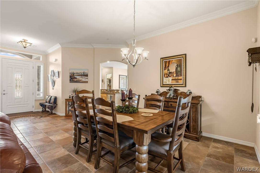 2708 Discovery Road Bullhead City, AZ 86442 - Photo 18 of 90 a view of a dining room with furniture and chandelier