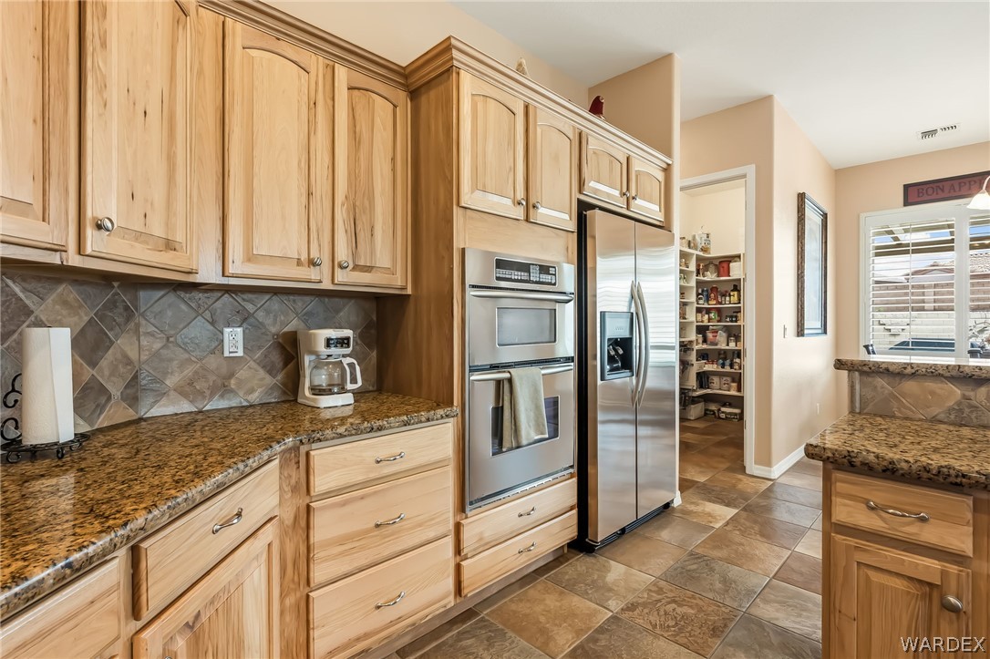 2708 Discovery Road Bullhead City, AZ 86442 - Photo 22 of 90 a kitchen with stainless steel appliances granite countertop a refrigerator and a stove