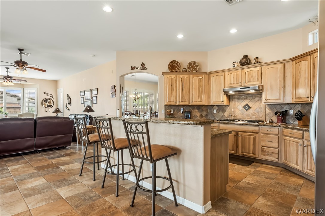 2708 Discovery Road Bullhead City, AZ 86442 - Photo 23 of 90 a kitchen with stainless steel appliances granite countertop a sink and a refrigerator