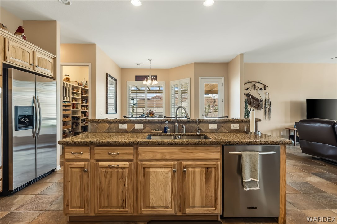 2708 Discovery Road Bullhead City, AZ 86442 - Photo 26 of 90 a kitchen with stainless steel appliances granite countertop a sink and a refrigerator