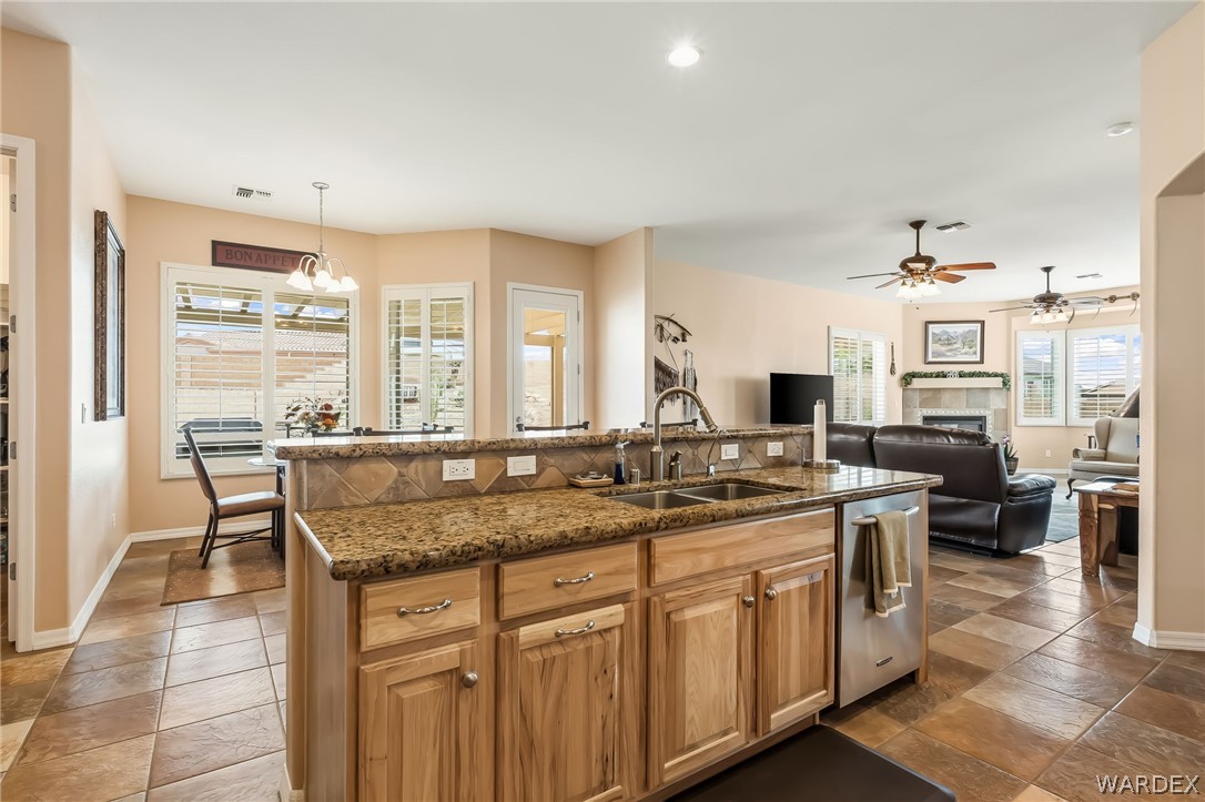 2708 Discovery Road Bullhead City, AZ 86442 - Photo 27 of 90 The kitchen features a functional island with a double basin sink and granite countertops